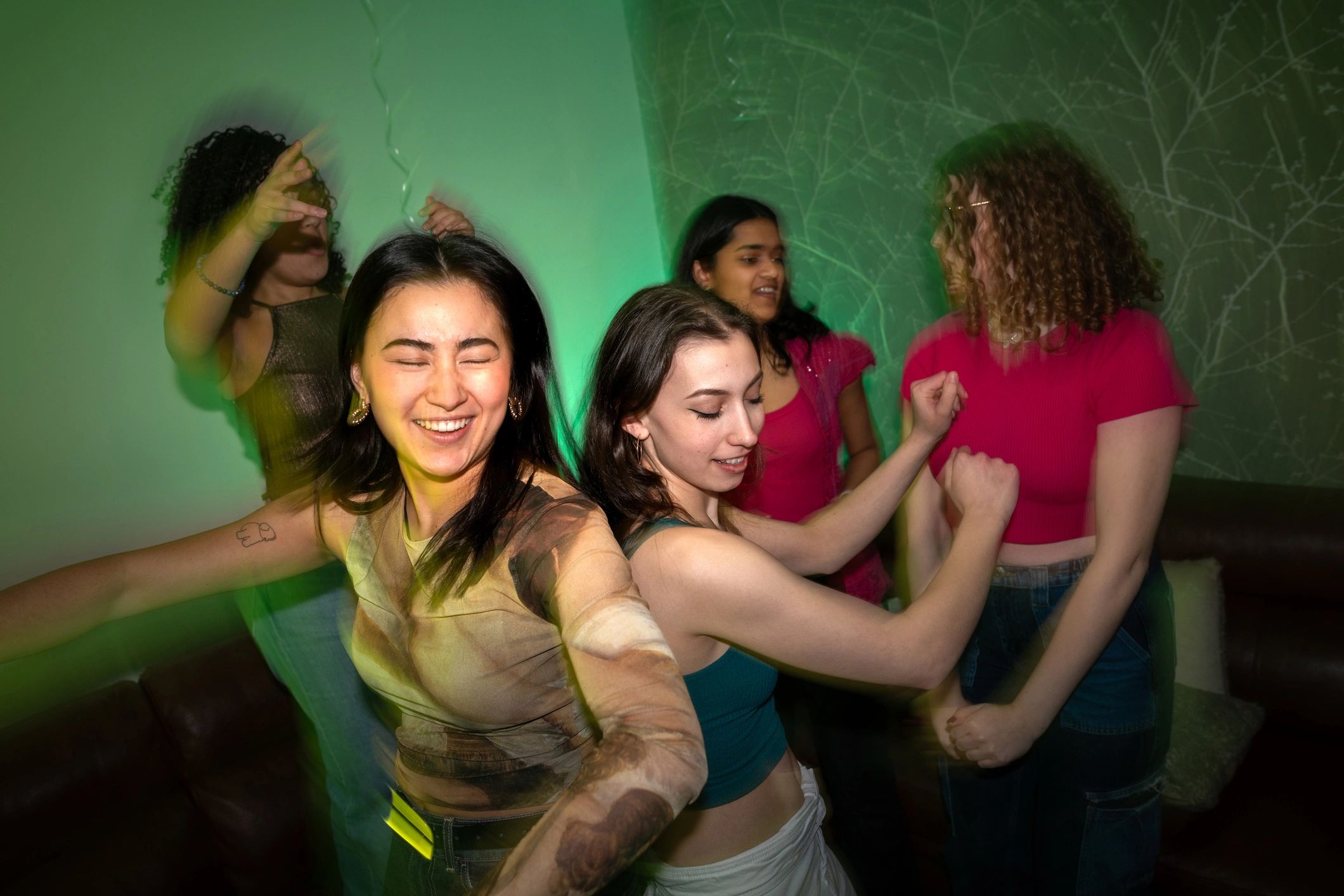 Friends dancing together during a social club night