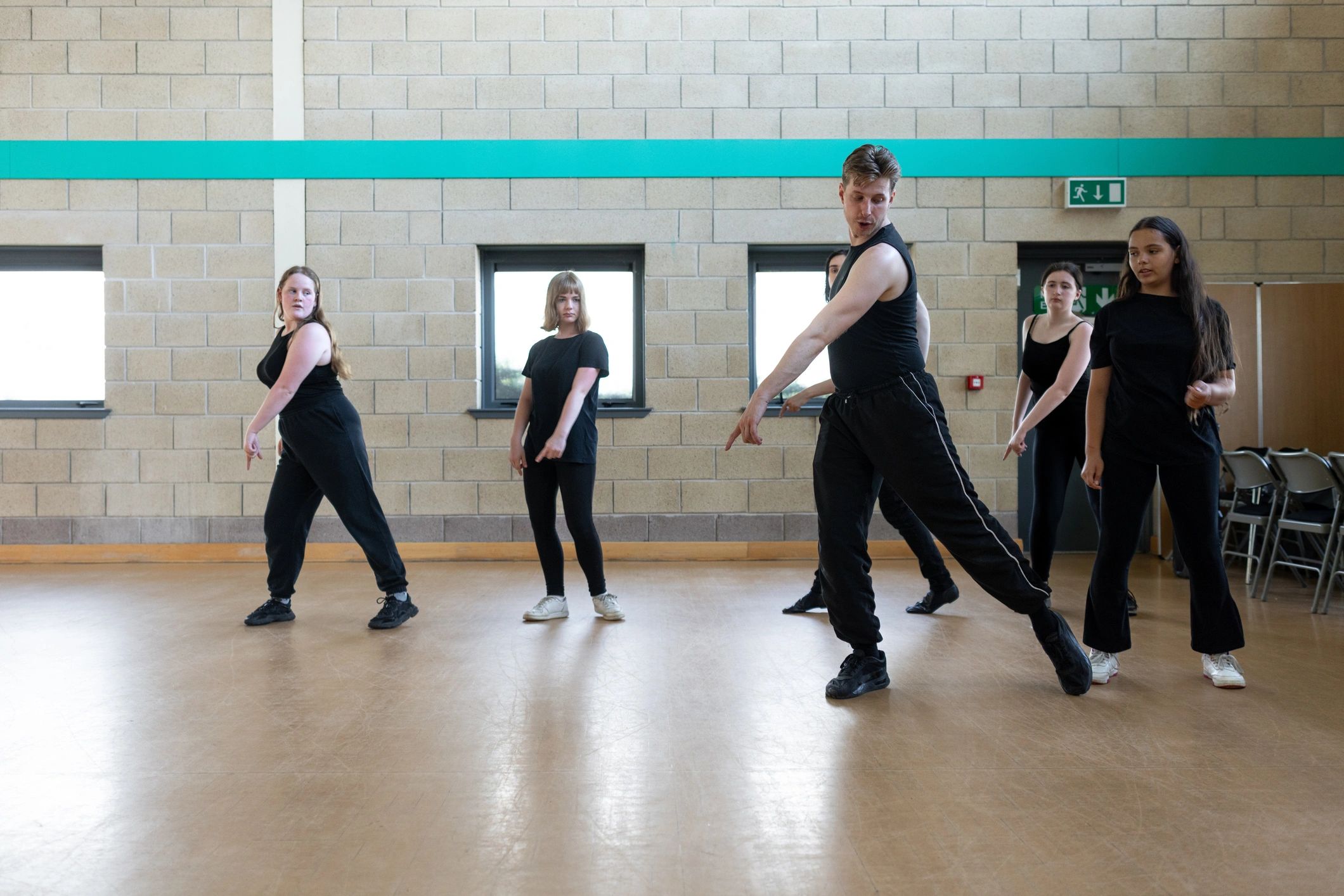 Group practicing coordinated dance movements